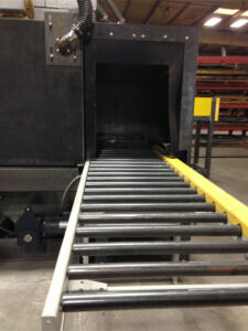 Close-up view of industrial roller conveyors used for transporting parts and materials through automated production and handling systems.