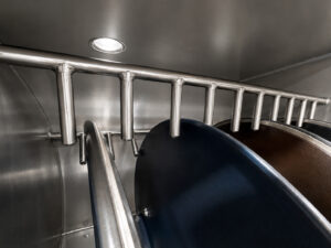 Drum lid holding slots inside an LS Industries Drum Lid Washer, designed to securely position multiple drum lids during the washing process for complete cleaning coverage.