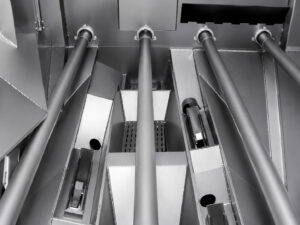 High-velocity blast wheels inside a plate blaster used to propel abrasive media onto steel plate surfaces for cleaning and surface preparation.