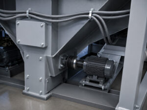 Heavy-duty impeller motor mounted on a plate blaster that powers the blast wheel system for high-performance abrasive blasting.