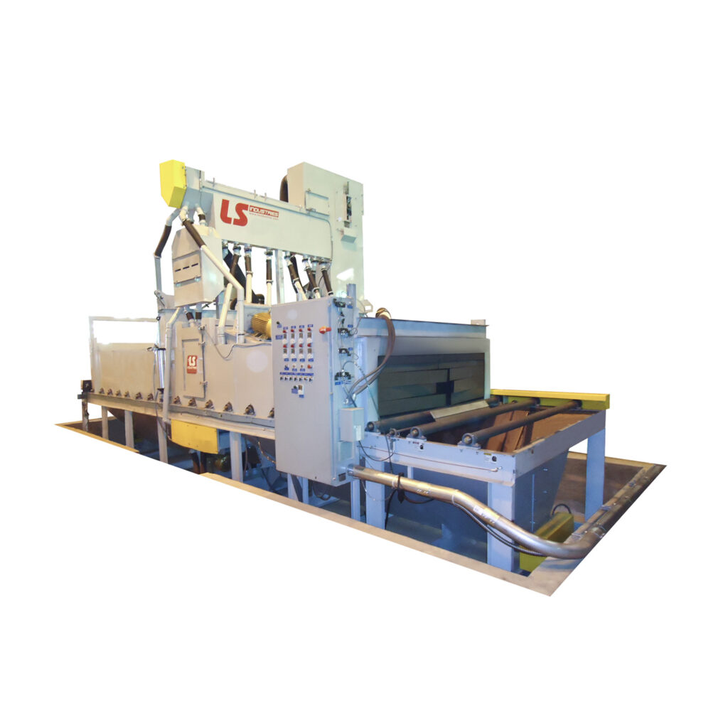 Angled view of an industrial plate blaster used for abrasive cleaning and surface preparation of flat steel plates.