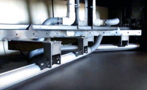 Plate plow with air knife in a plate blaster used to remove and direct abrasive media from steel plates after blasting.
