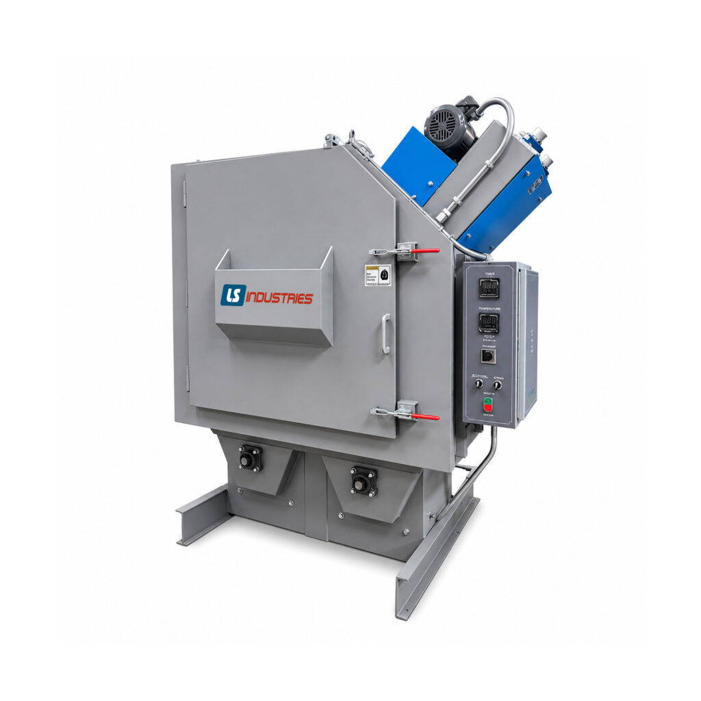 Angled view of a batch drum blaster designed to clean and prepare steel drums, barrels, and cylindrical containers through automated abrasive blasting.